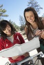 Two Young Women With Mountain Bikes Reading Map Royalty Free Stock Photo