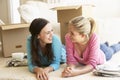 Two Young Women Moving Into New Home Unpacking Boxes Royalty Free Stock Photo