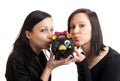 Two young women piggy bank kissing