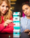 Two young women playing colored jenga