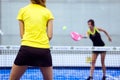 Two young women playing paddle tennis. Royalty Free Stock Photo