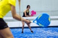 Two young women playing paddle tennis. Royalty Free Stock Photo