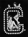 Two young women posing with the letter C Royalty Free Stock Photo