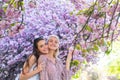 Two young women relaxing in sakura flowers. Spring girls. Royalty Free Stock Photo