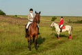 Two young women riding horse in park. Horse walk in summer Royalty Free Stock Photo