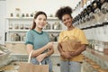 Two young women shopped in refill store, reusable bags, and zero-waste grocery Royalty Free Stock Photo