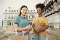 Two young women shopped in refill store, reusable bags, and zero-waste grocery Royalty Free Stock Photo