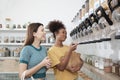 Two young women shopped in refill store, reusable bags, and zero-waste grocery Royalty Free Stock Photo