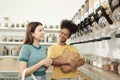 Two young women shopped in refill store, reusable bags, and zero-waste grocery Royalty Free Stock Photo