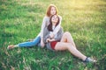 Two young women sitting on the field Royalty Free Stock Photo