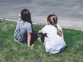 Two young women sitting on grass, rear view Royalty Free Stock Photo