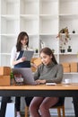 Two women small business entrepreneurs working together in home office. Online selling concept. Royalty Free Stock Photo