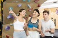 Two young women and teen boy talking at climbing wall Royalty Free Stock Photo