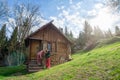 Two young women standing in front of an old hut in the forest Royalty Free Stock Photo