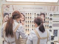 Two young women standing in front of a shelf with Korean cosmetics Royalty Free Stock Photo