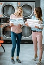 Women with clean clothes in the laundry