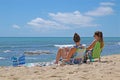 Two young women sunbathing on a beach on Oahu, Hawaiilu Royalty Free Stock Photo