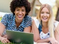 Two young women with tablet in park