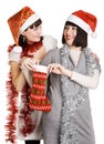 Two young women taking out their Christmas present Royalty Free Stock Photo
