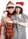 Two young women taking out their Christmas present Royalty Free Stock Photo