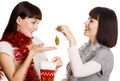 Two young women taking out their Christmas present Royalty Free Stock Photo