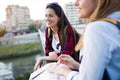 Two young women tourist using their map in the city.