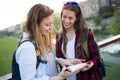 Two young women tourist using their map in the city.