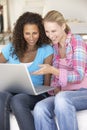 Two Young Women Using Laptop Computer At Home Royalty Free Stock Photo