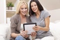 Two Young Women Using Tablet Computer At Home Royalty Free Stock Photo