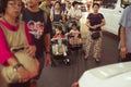 Two young women walk with baby carriages along the busy Yaowarat Road - Bangkok, Thailand