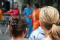 Two young women watching samba band performance