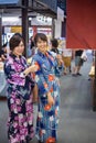 Two young woman wearing japanese traditional kimono enjoy the stroll Royalty Free Stock Photo