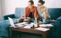 Two young women are working at home on a project, sitting in front of a laptop and talking on a video conference Royalty Free Stock Photo