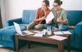 Two young women are working at home on a project, sitting in front of a laptop and talking on a video conference Royalty Free Stock Photo