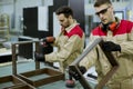 Two young workers assembling furniture in the factory Royalty Free Stock Photo