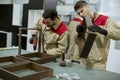 Two young workers assembling furniture in the factory Royalty Free Stock Photo