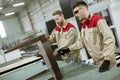 Two young workers assembling furniture in the factory Royalty Free Stock Photo