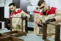 Two young workers assembling furniture in the factory Royalty Free Stock Photo