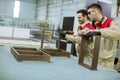 Two young workers assembling furniture in the factory Royalty Free Stock Photo