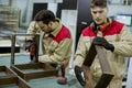 Two young workers assembling furniture in the factory Royalty Free Stock Photo