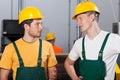 Two young workers in production area