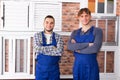 Two young workmen inspecting windows Royalty Free Stock Photo