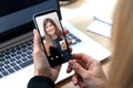 Two youngs woman talking to each other through a video call on a smartphone.