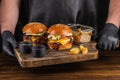 Two yummy big grilled burger with double meat cutlet and cheese on a wooden board ready to eat. Burger and fries. Royalty Free Stock Photo