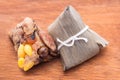 Two Zongzi or Asian Chinese sticky rice dumplings on wooden back
