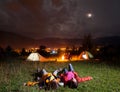 Twosome admiring the bright stars and lying on the grass Royalty Free Stock Photo