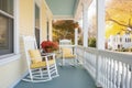 twostory colonial, side porches with rocking chairs