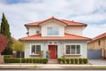 twostory mediterranean house with red tiled roof