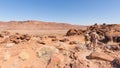 Twyfelfontein, Namibia - August 27, 2016: Group of tourists walking in the desert at Twyfelfontein, world heritage rock engravings