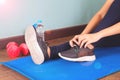 Tying sport shoes, Asian woman getting ready for weight training. Exercise, Fitness training. Healthy lifestyle Royalty Free Stock Photo